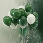 Colorful Polka Dot Balloons with Confetti on Soft Green Background