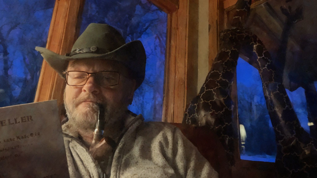 Cowboy hat and glasses person with paper and pipe indoors at twilight.