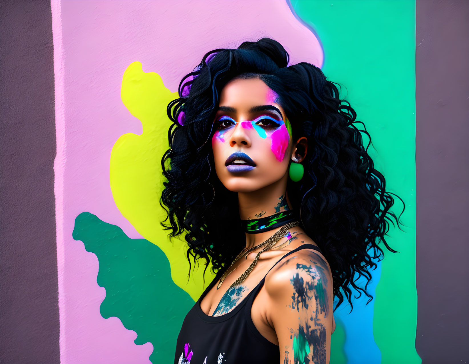 Vibrant makeup woman with curly hair in front of colorful mural