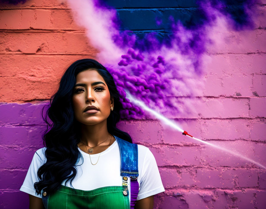 Woman standing in front of colorful brick wall with purple smoke.