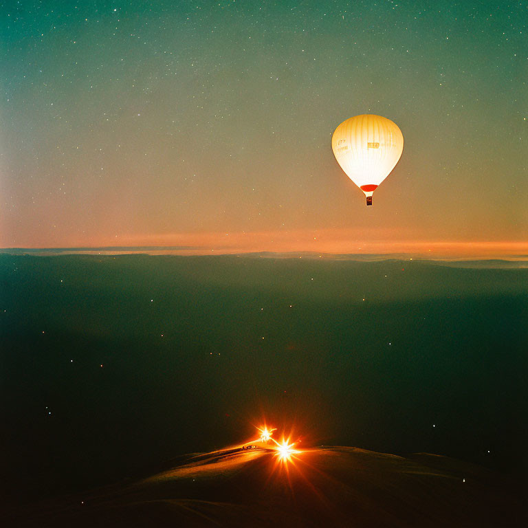 Twilight hot air balloon with glowing horizon and starry sky.