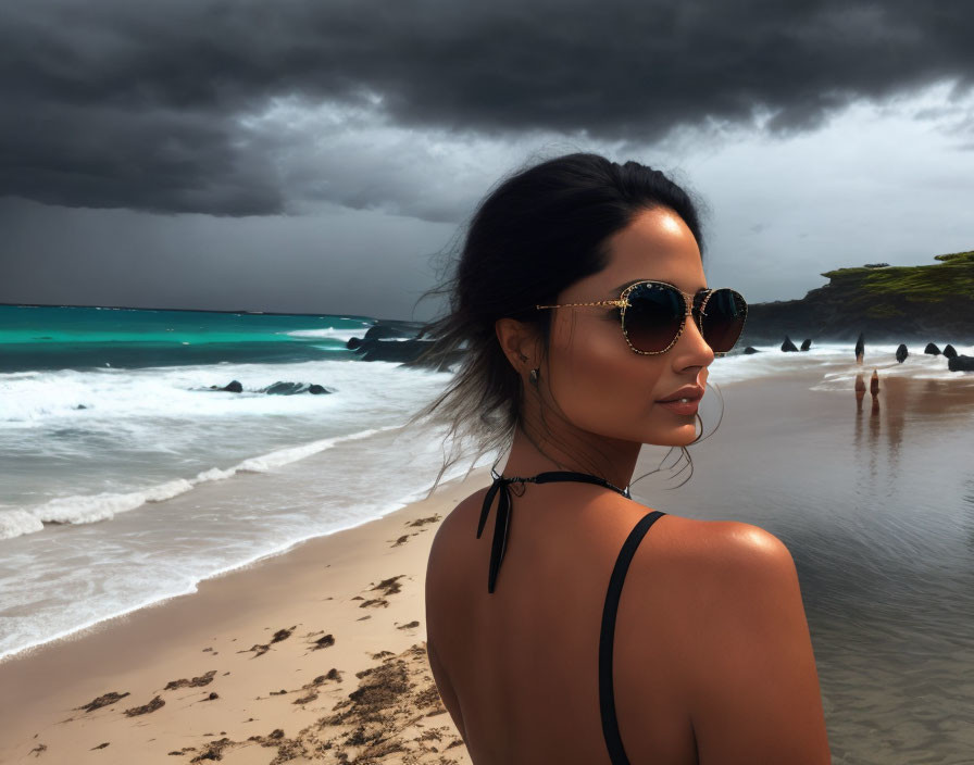Woman in sunglasses gazes at stormy beach with dark clouds and turbulent sea