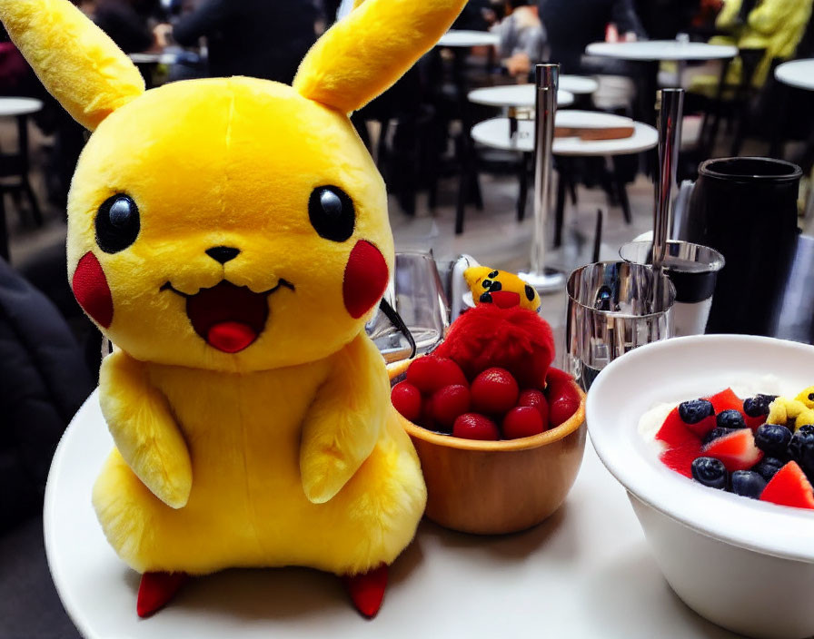 Plush Pikachu toy with cherries and yogurt in a cafe setting