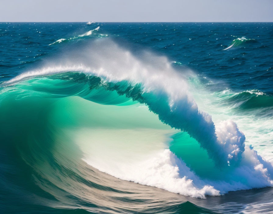 Turquoise Wave with White Foam in Blue Ocean and Sky