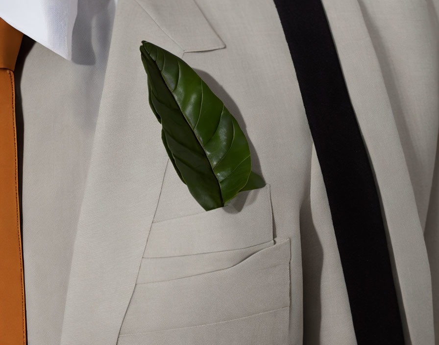 Green leaf accents beige suit jacket with black tie hint