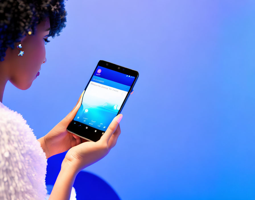 Woman holding smartphone against blue background