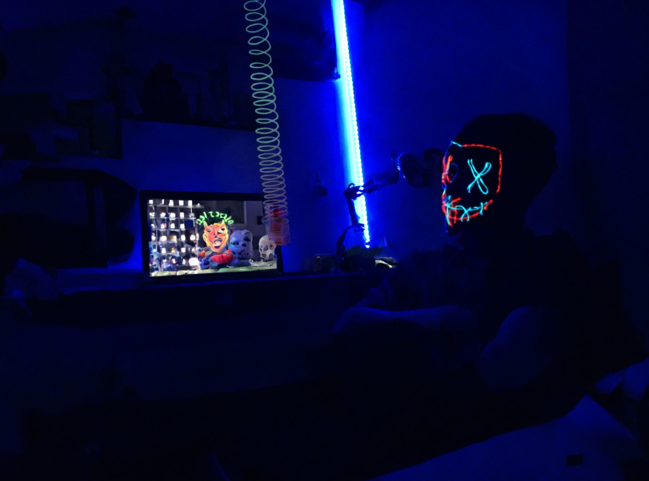 Dimly Lit Room with Blue Hue and Person Wearing Headphones