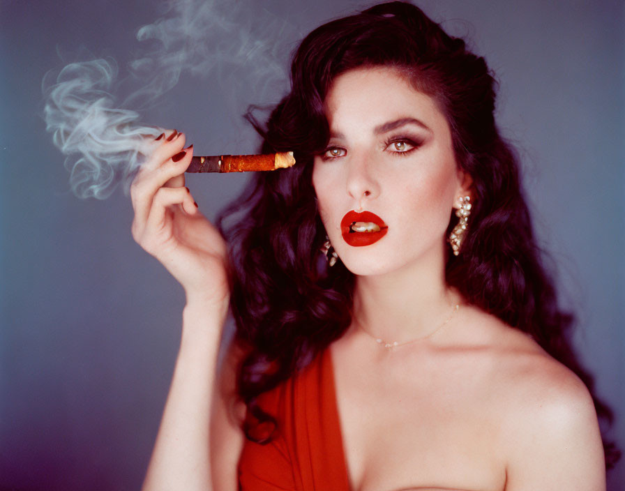 Woman with Red Lipstick and Earrings Smoking Cigar on Blue Background