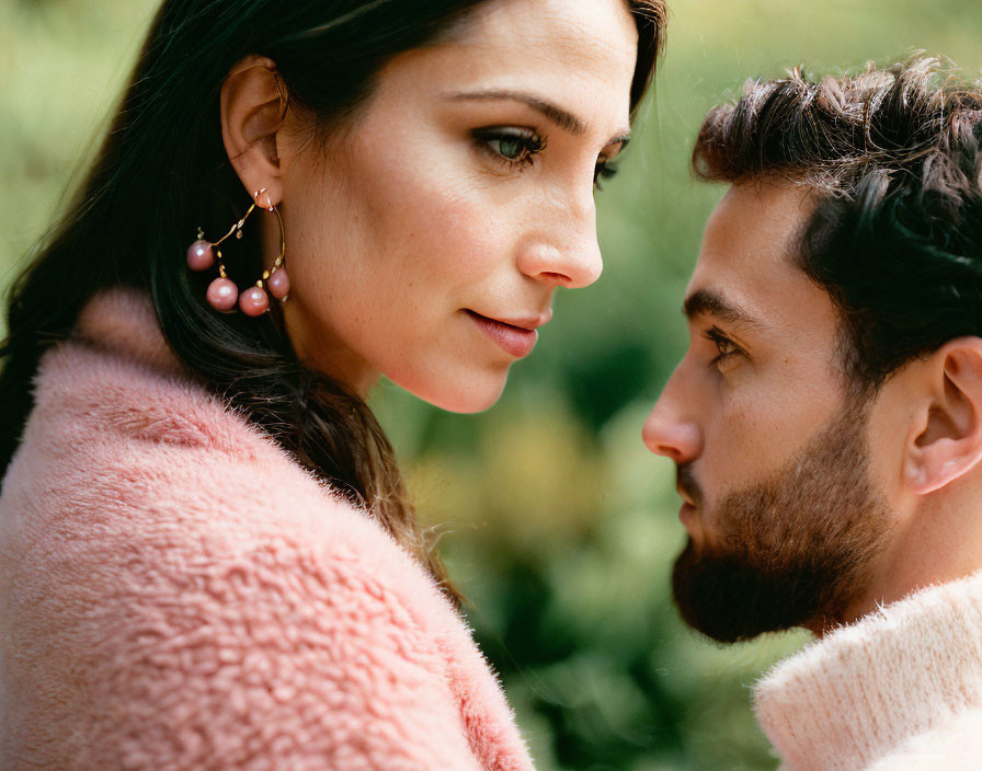 Woman in Pink Coat and Pearl Earrings with Bearded Man Sharing Intimate Moment