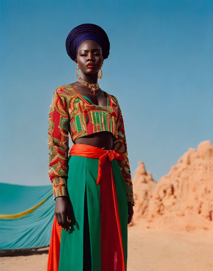 Traditional African attire woman confidently standing in desert scenery