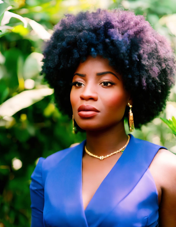 Woman with Afro Hairstyle in Blue Top and Gold Jewelry on Green Background