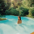 Beige Swimsuit Woman in Outdoor Pool with Greenery