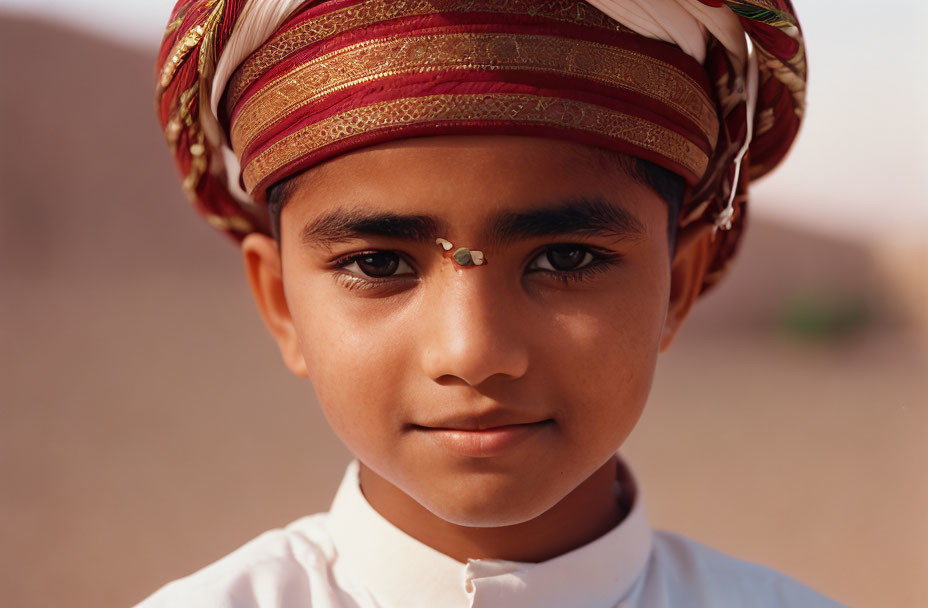 Traditional attire: Young boy in colorful turban and forehead decoration