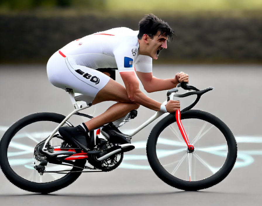 Competitive cyclist in white and red outfit on race bike.