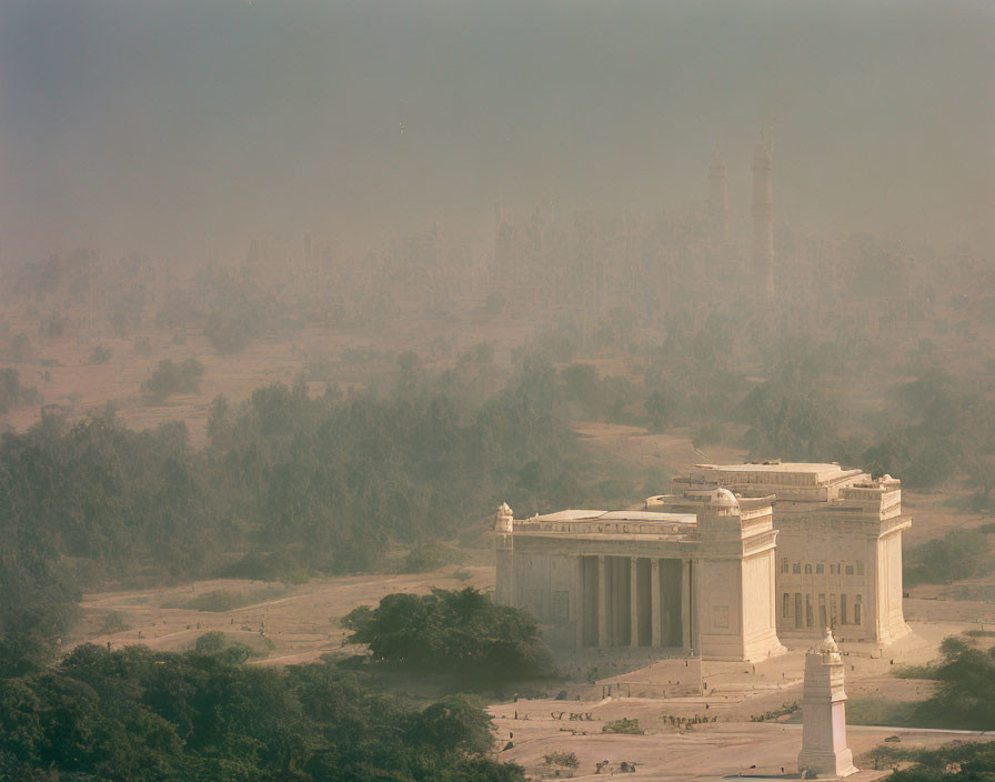 Historical building in misty landscape with minaret and trees.