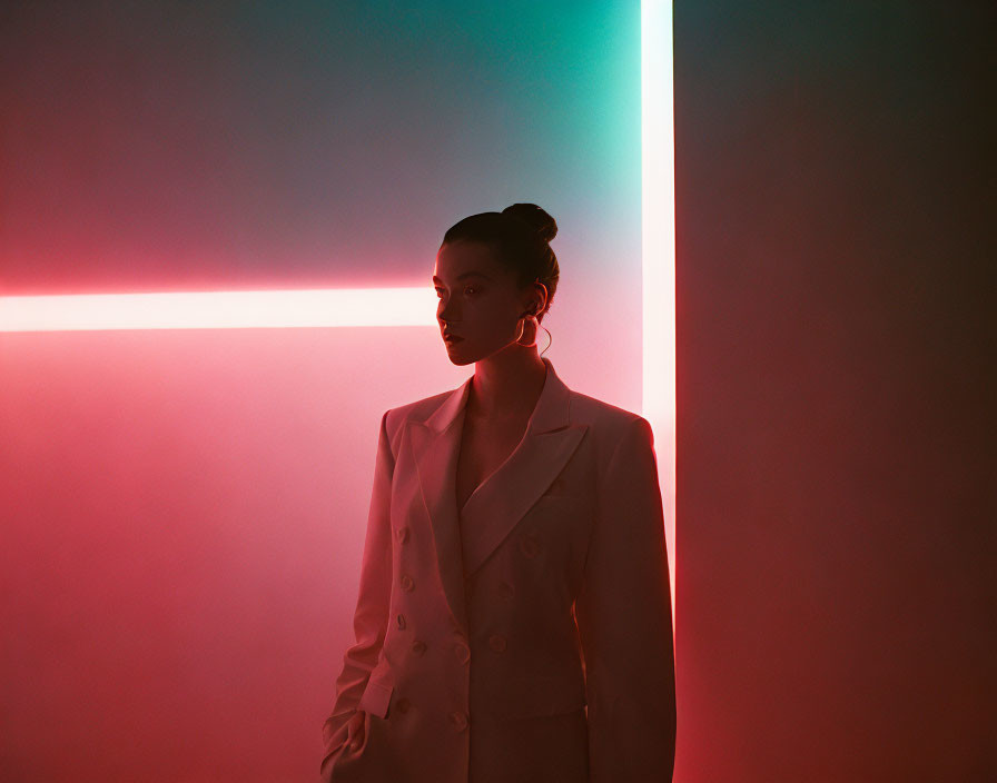 Contemplative woman in white blazer under neon pink and blue lights