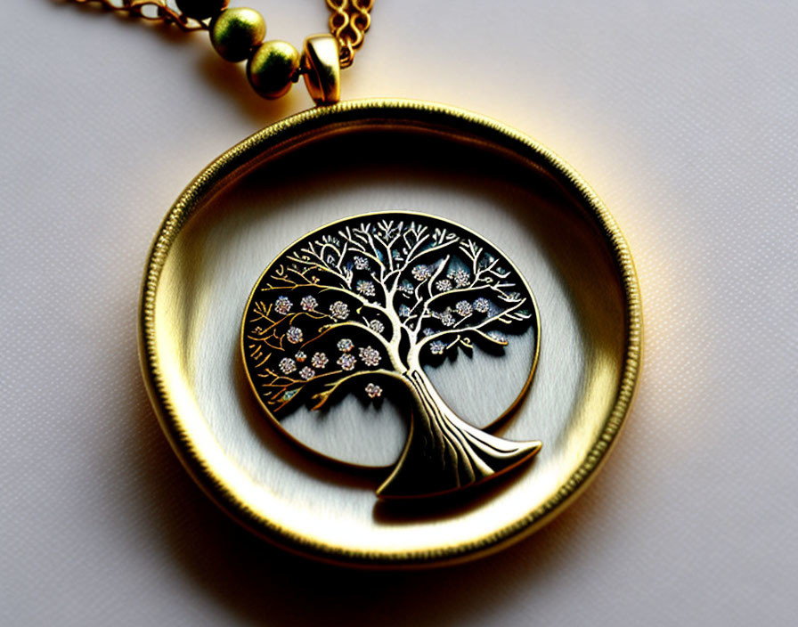 Golden Tree Design Pendant with Sparkling Branch Accents on Light Background