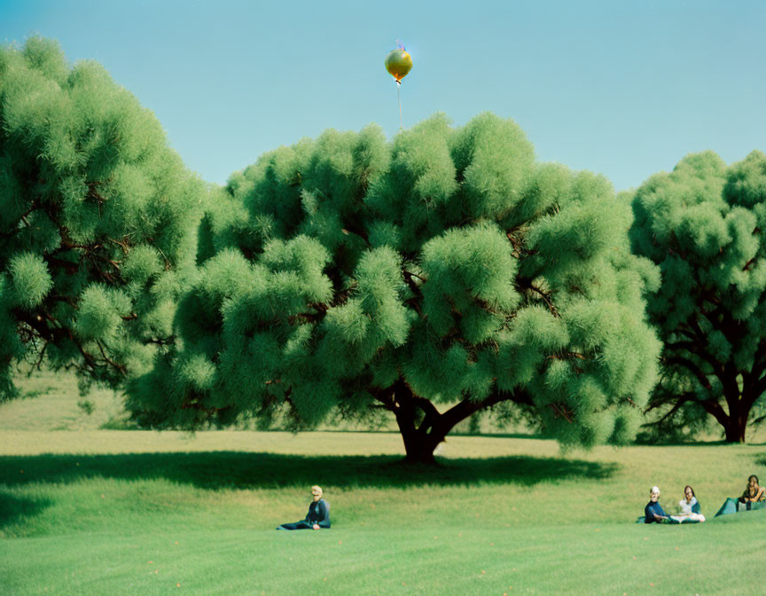 Tranquil park scene with people under green trees and colorful balloon in blue sky