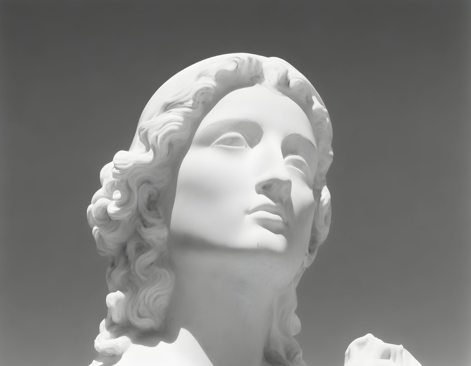 White marble statue of woman with wavy hair on light background