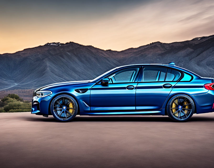 Blue Sports Sedan with Golden Brake Calipers on Mountainous Road