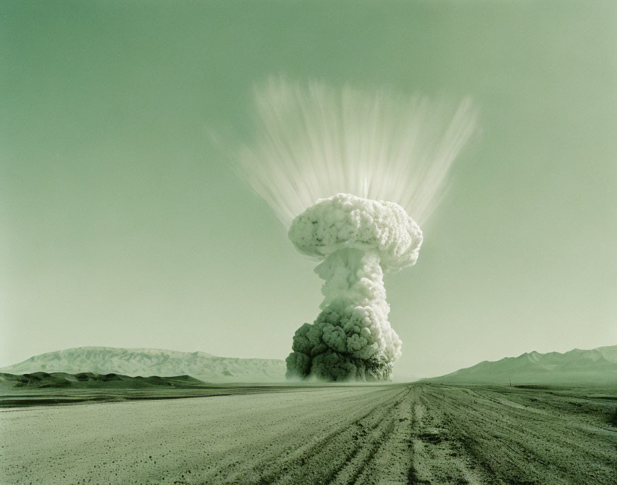 Explosion creates large mushroom cloud over desert landscape