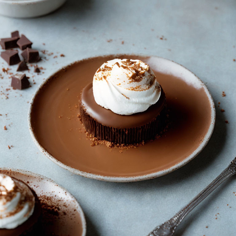 Chocolate dessert with whipped cream and cocoa on brown plate