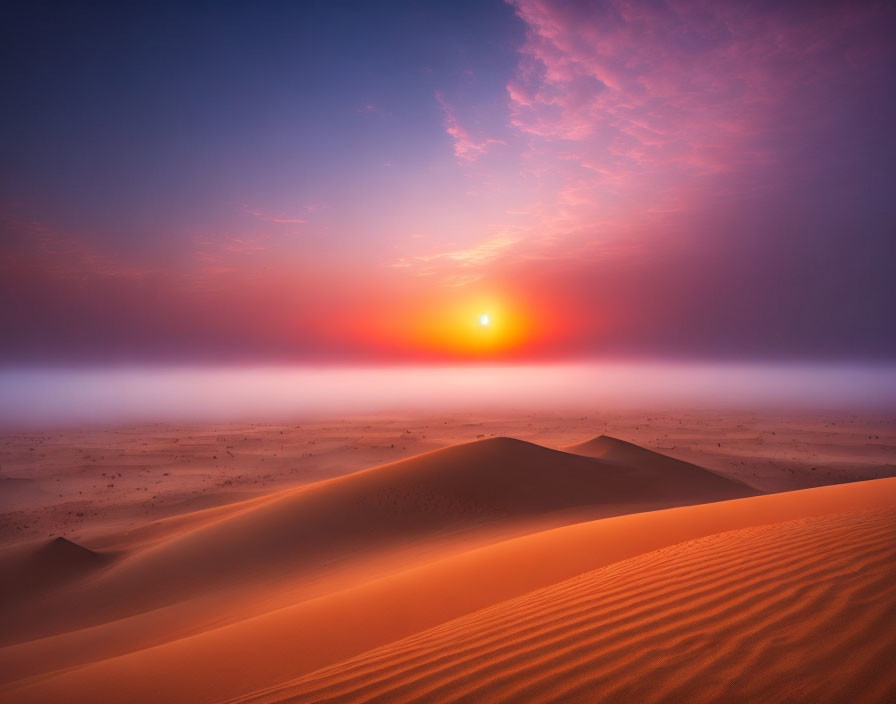 Vibrant orange and purple desert sunset with misty horizon