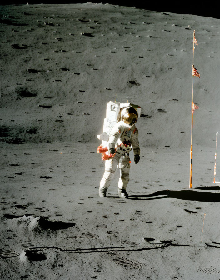 Astronaut in white spacesuit on moon with US flag patch