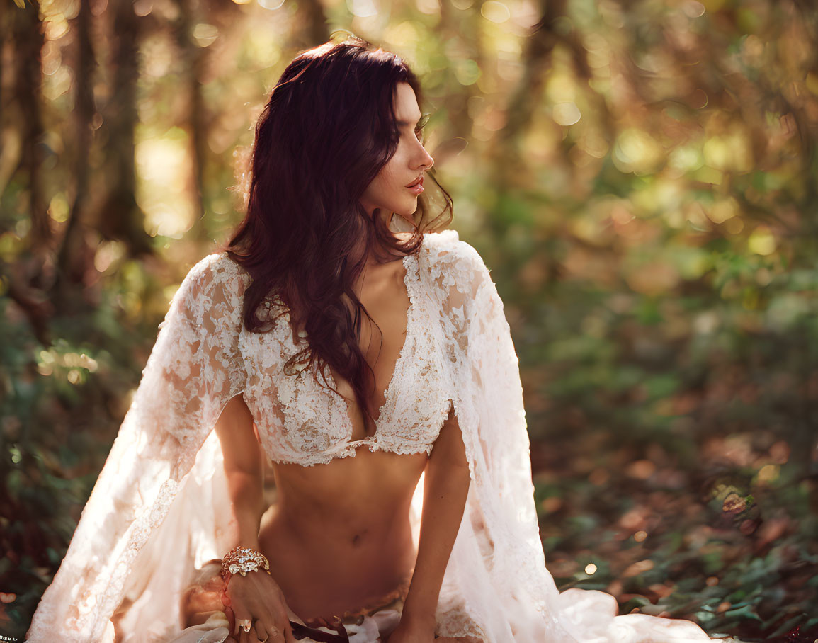 Bridal woman in lace dress in sunlit forest portrait