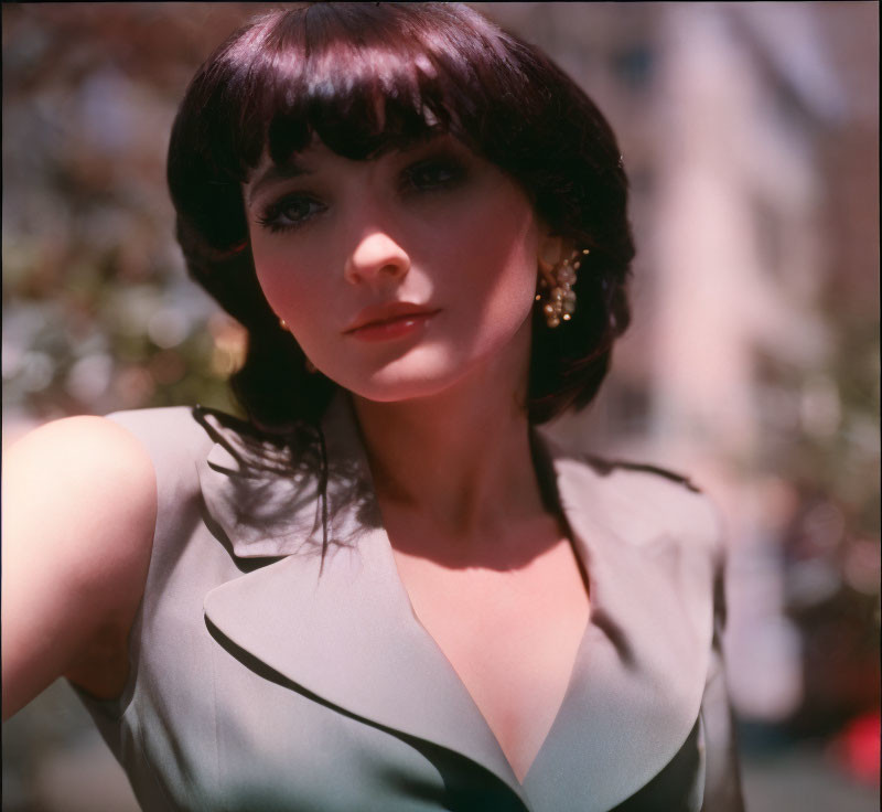 Dark-Haired Woman in Bob Cut and Hoop Earrings in Soft-Focus Portrait