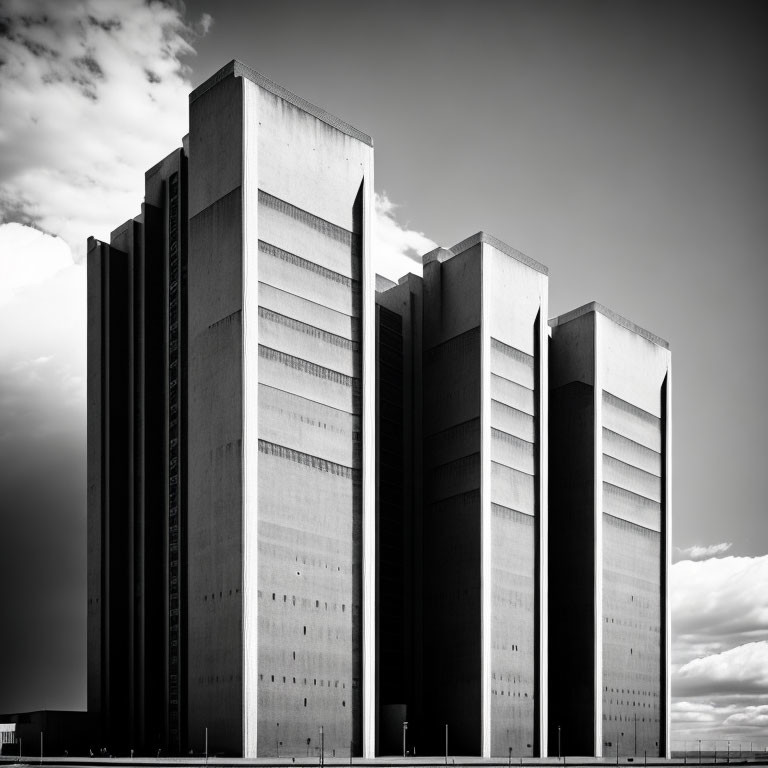 Monochrome photo of modern high-rise buildings against dramatic sky