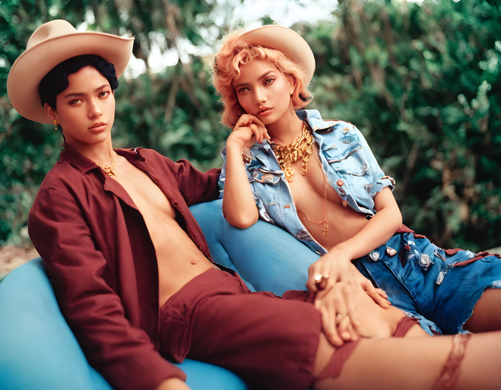 Stylish individuals in cowboy hats and chic outfits lounging in nature