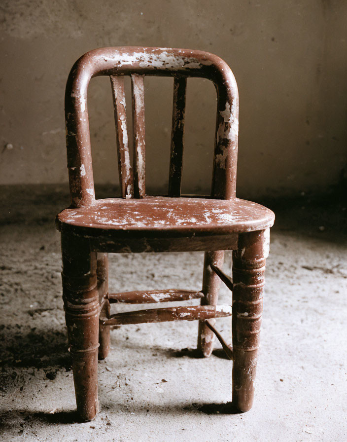 Weathered Brown Chair Against Grey Textured Background