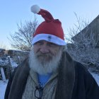 Detailed Close-Up of Smiling Santa Claus in Snowy Village