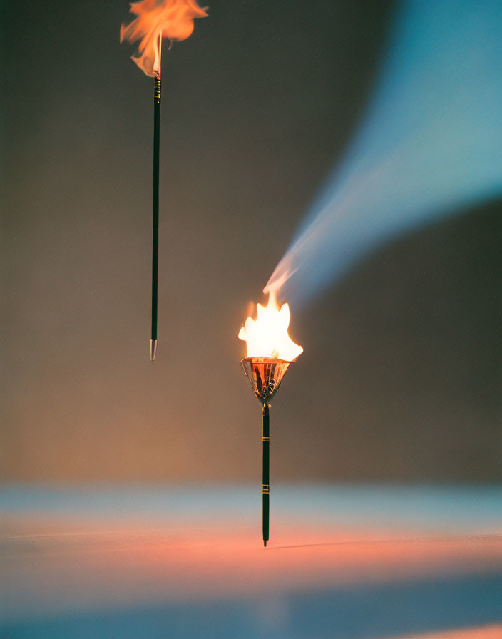 Flaming torches on gradient background with smoke