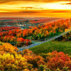 Colorful Autumn Landscape with Suspension Bridge and Sunset Sky