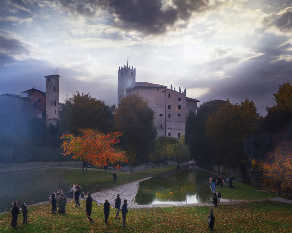 Historic castle at dusk with dramatic clouds, reflective pond, and autumnal garden.