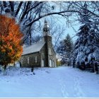 Tranquil lakeside cabin in autumn snowfall