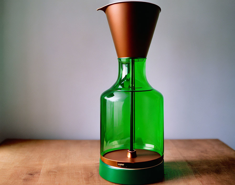 Green Glass Coffee Maker with Copper Funnel on Wooden Table