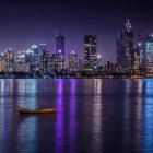 Nighttime cityscape with illuminated skyscrapers, boat, and dramatic sky