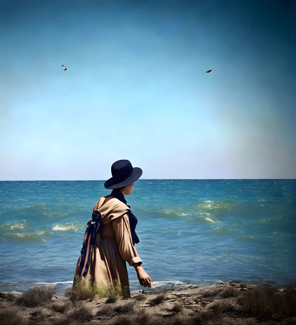 Person in trench coat and wide-brimmed hat by calm sea with birds and clear blue sky