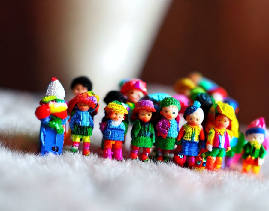 Colorful Miniature Knitted Dolls on Fuzzy Surface