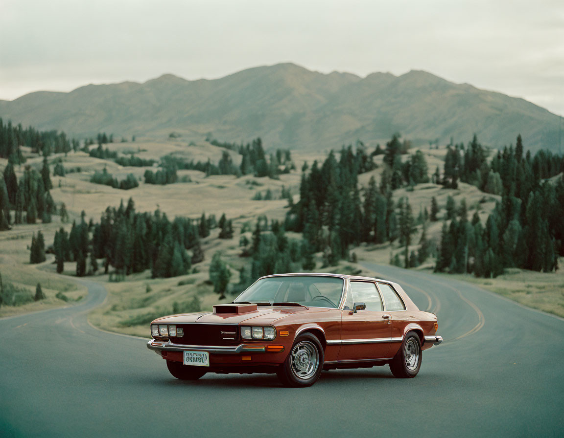 Classic Red Car Parked on Winding Road Amid Green Hills