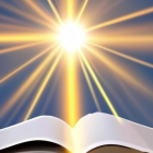 Ornate open book with glowing pages under bright sun