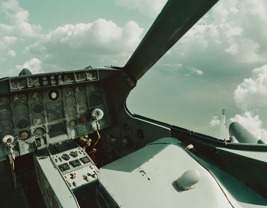 Aircraft cockpit with flight instruments, control panel, wing view