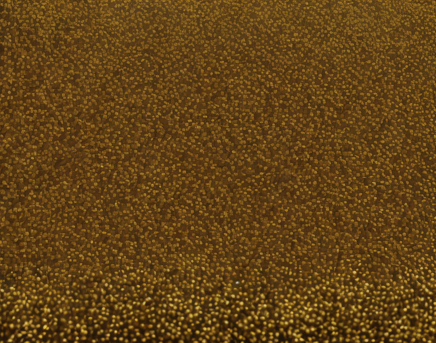 Shimmering gold surface with sparkling speckles