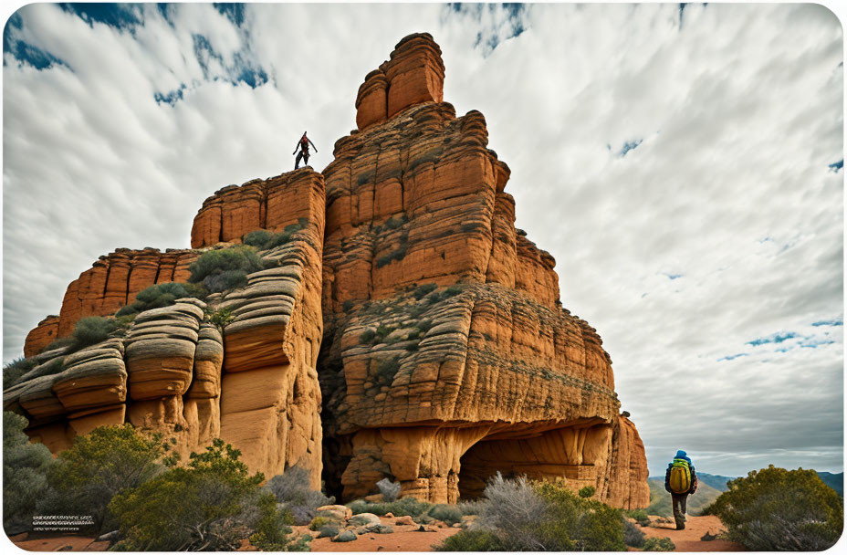 Hikers on Sandstone Formation Under Dramatic Sky