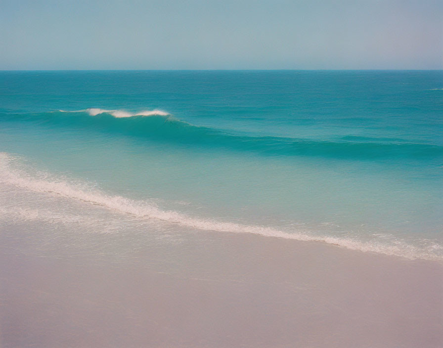 Tranquil ocean scene with soft waves and gradient blue sky