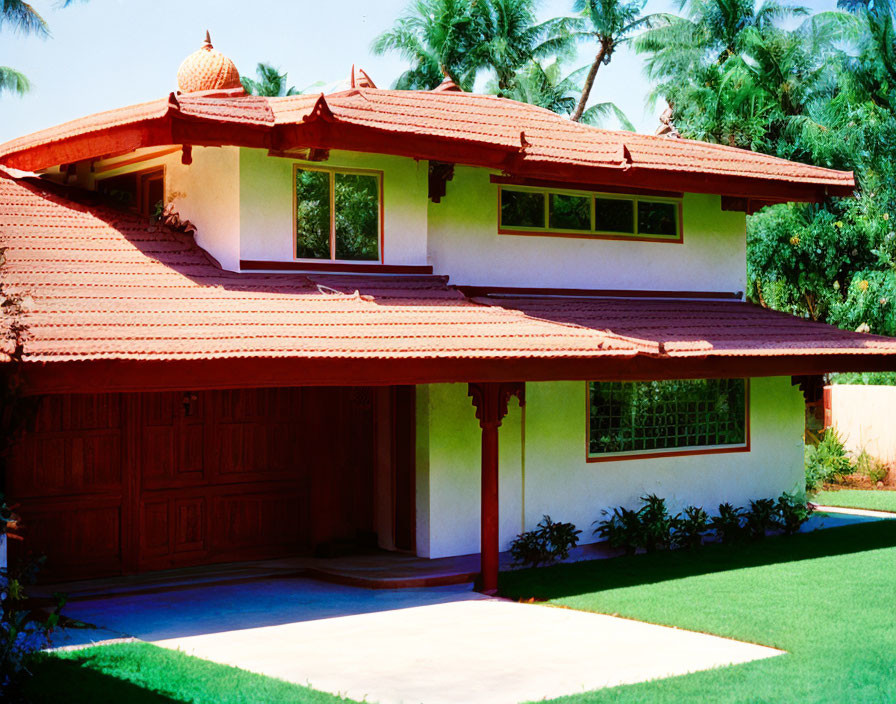 Traditional-style house with red tile roof, white walls, wooden garage door, set in lush green lawn