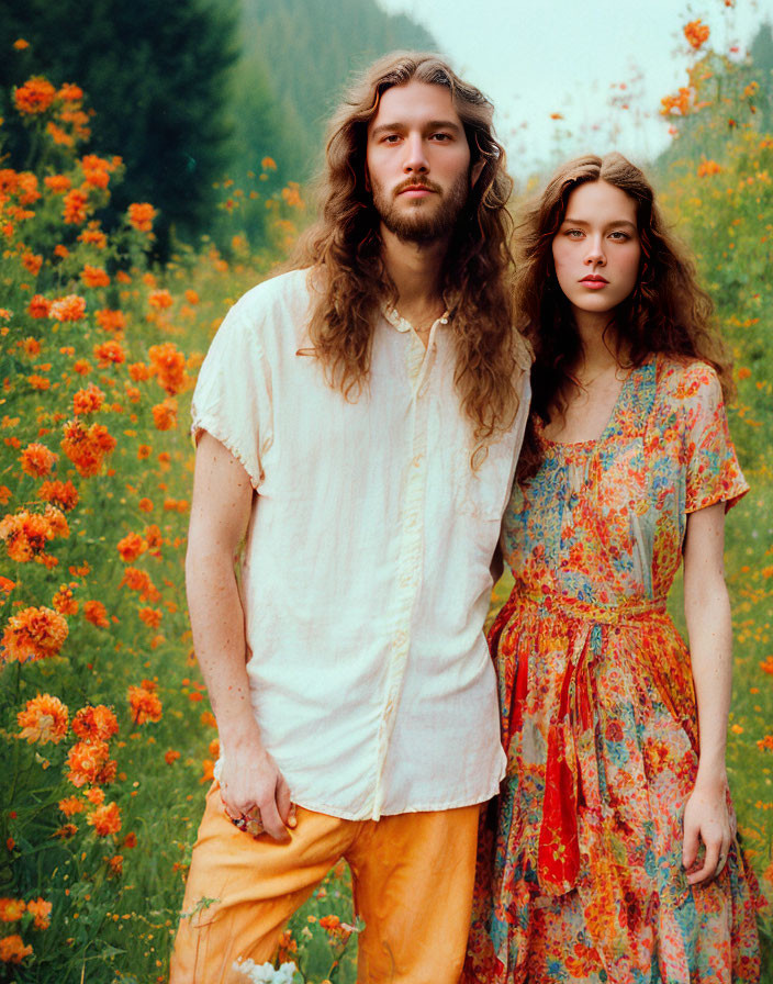 Couple in Bohemian Attire Surrounded by Orange Flowers